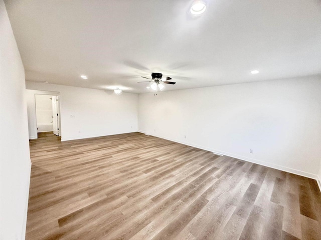 spare room featuring ceiling fan and light wood-type flooring