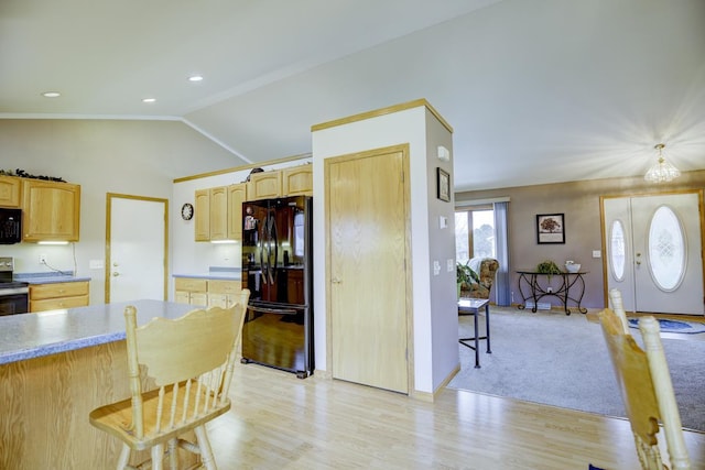 kitchen with a kitchen breakfast bar, light hardwood / wood-style floors, vaulted ceiling, light brown cabinetry, and black appliances