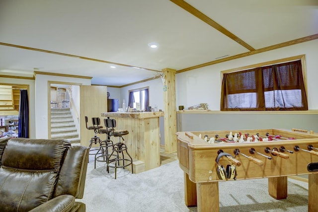 recreation room featuring light carpet, bar, and ornamental molding