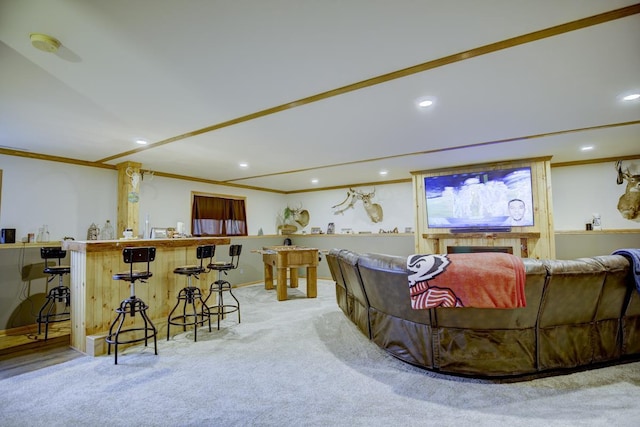 carpeted living room with bar and crown molding