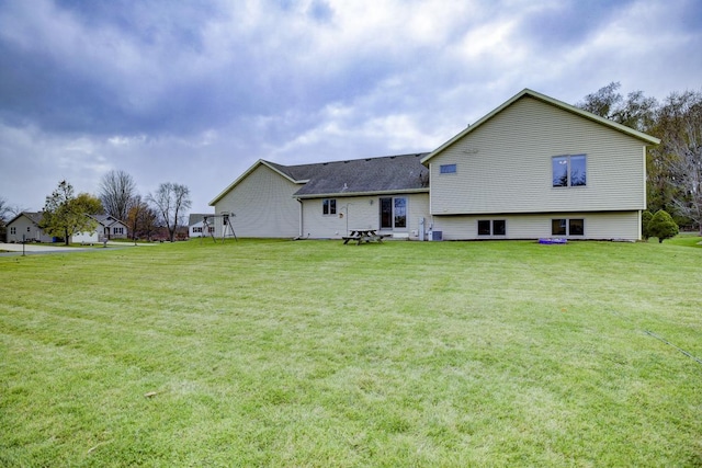 rear view of property featuring a yard