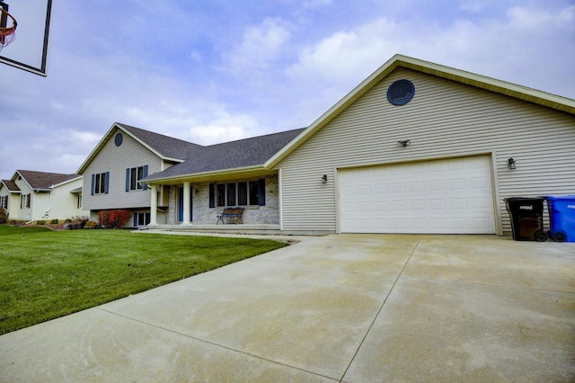 view of front of house featuring a front lawn, covered porch, and a garage