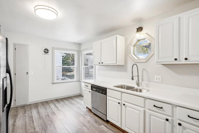 kitchen with white cabinets, light wood-type flooring, sink, and appliances with stainless steel finishes