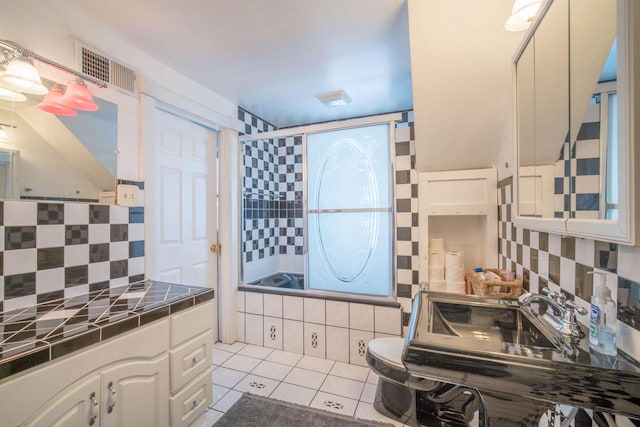 bathroom with tile patterned floors, backsplash, and toilet