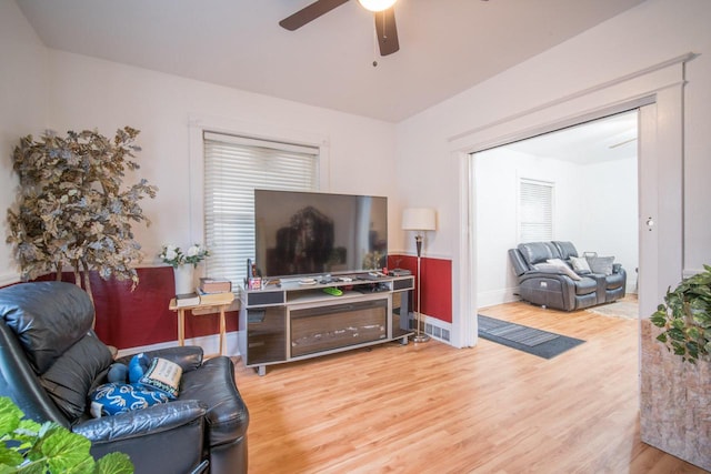 living room with hardwood / wood-style flooring and ceiling fan