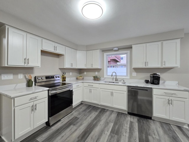 kitchen with white cabinets, appliances with stainless steel finishes, and sink