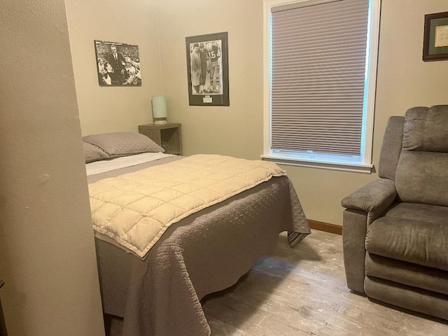 bedroom with hardwood / wood-style flooring