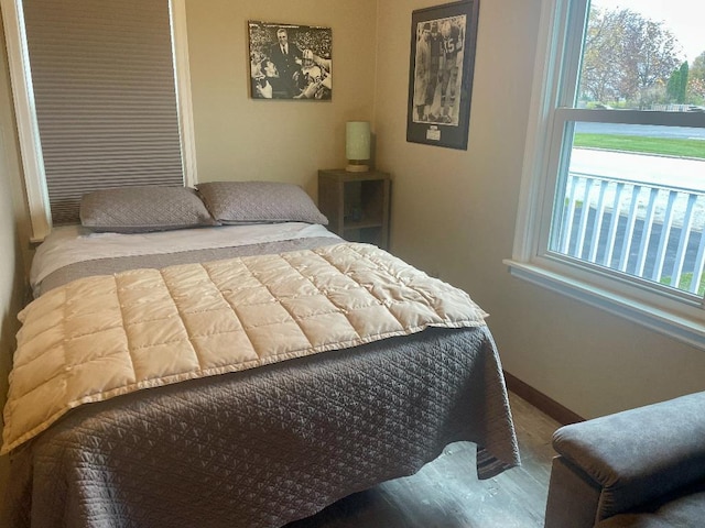 bedroom with hardwood / wood-style flooring