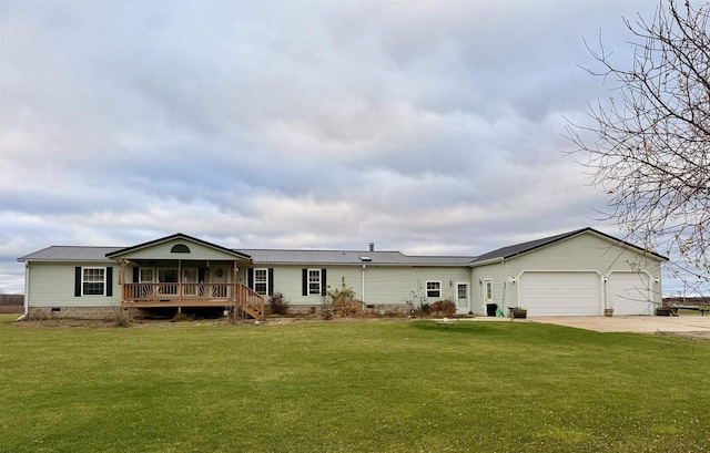 view of front of property with a garage and a front lawn