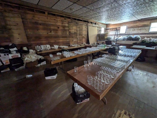 dining area featuring hardwood / wood-style floors and wood walls