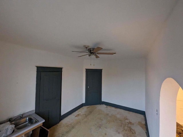 interior space with ceiling fan