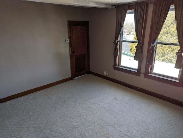 unfurnished room with light colored carpet