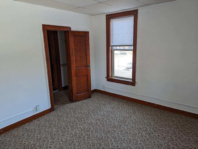 unfurnished room with a paneled ceiling