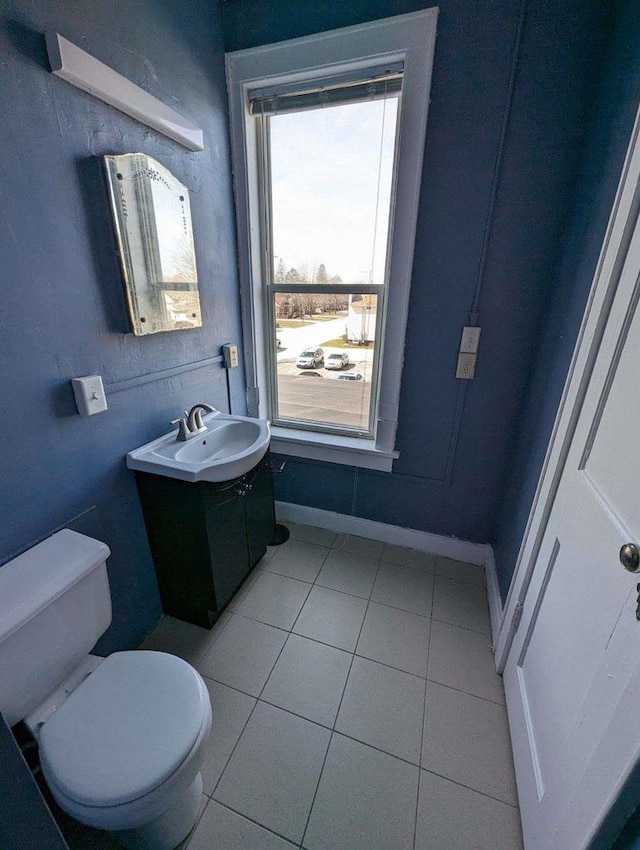 bathroom with tile patterned flooring, vanity, and toilet