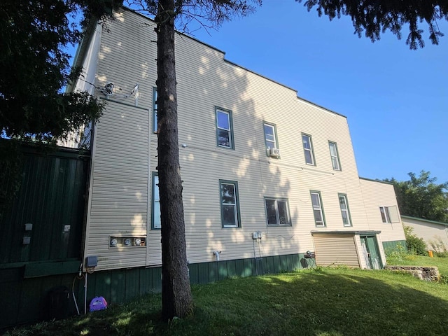 view of side of home featuring a lawn