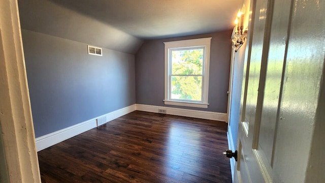 bonus room with dark hardwood / wood-style flooring and lofted ceiling