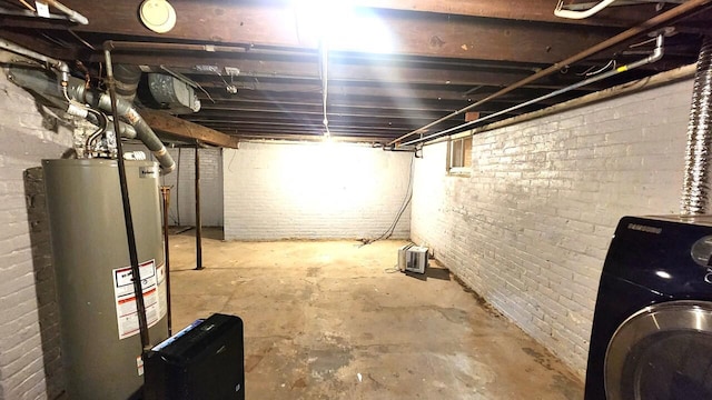 basement featuring washer / clothes dryer and water heater