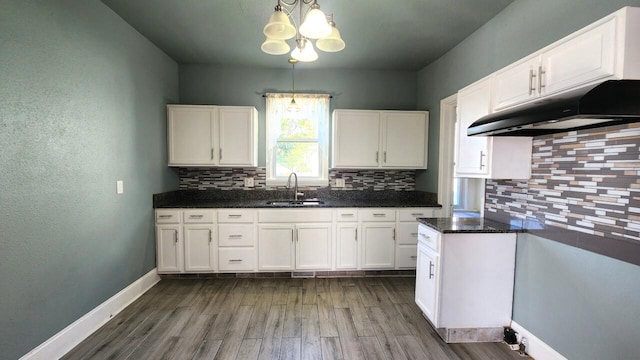 kitchen featuring decorative backsplash, pendant lighting, dark hardwood / wood-style flooring, and white cabinetry