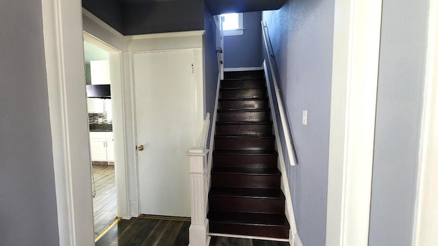 stairway with hardwood / wood-style flooring