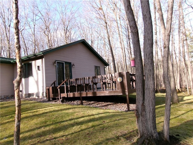 back of house with a lawn and a wooden deck