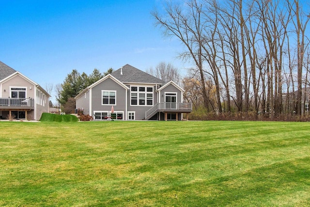 back of house with a deck and a yard