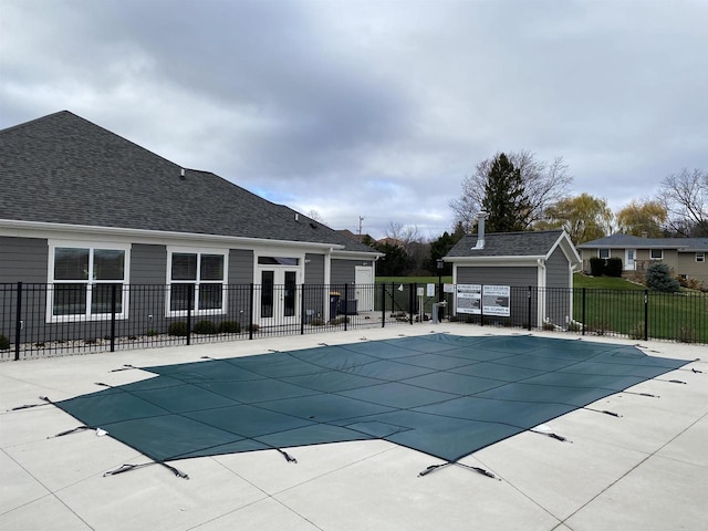 view of swimming pool featuring an outbuilding and a patio