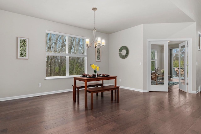 dining room featuring dark hardwood / wood-style floors and a notable chandelier