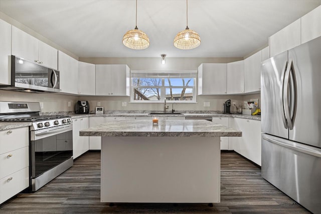 kitchen featuring white cabinetry, sink, a center island, and appliances with stainless steel finishes