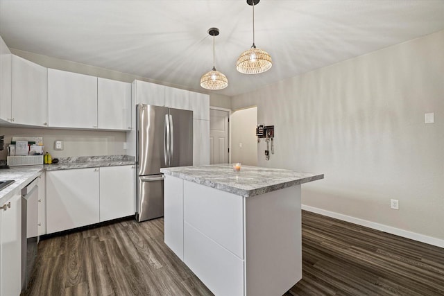 kitchen with white cabinets, pendant lighting, a kitchen island, and stainless steel appliances