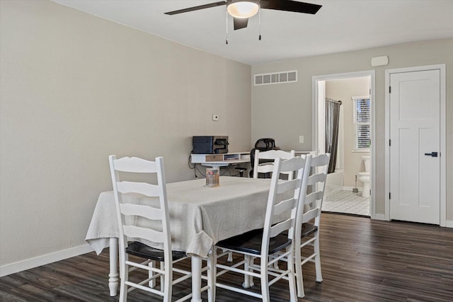 dining room with dark hardwood / wood-style flooring