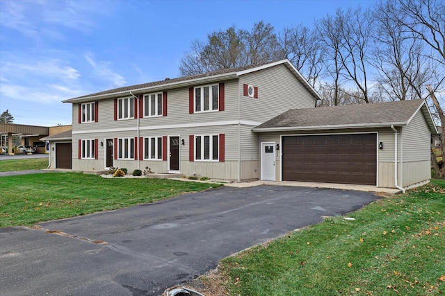 view of front of property with a front yard and a garage