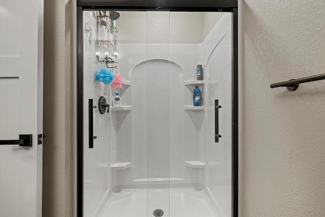 bathroom with a shower with shower door