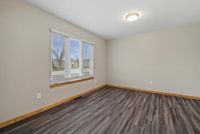 spare room featuring dark hardwood / wood-style flooring