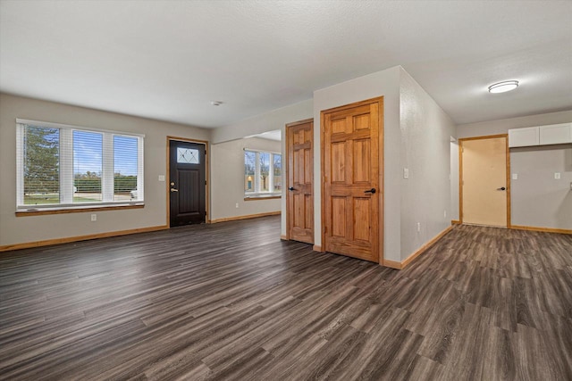 entryway with dark hardwood / wood-style flooring and a textured ceiling