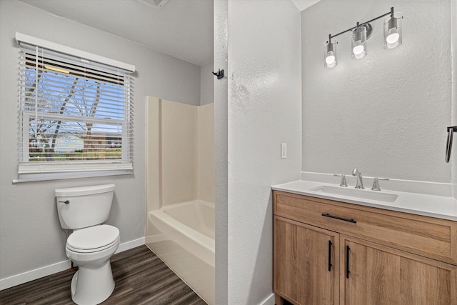 full bathroom featuring hardwood / wood-style floors, vanity, shower / bathtub combination, and toilet