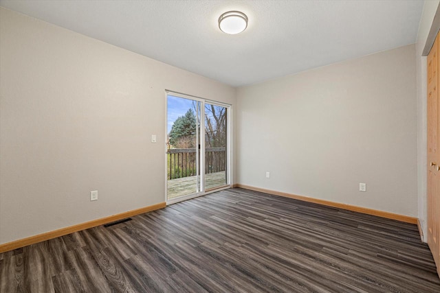 unfurnished room featuring dark wood-type flooring