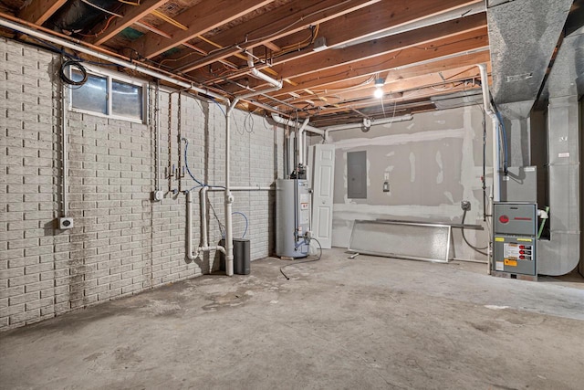 basement featuring brick wall, electric panel, heating unit, and water heater