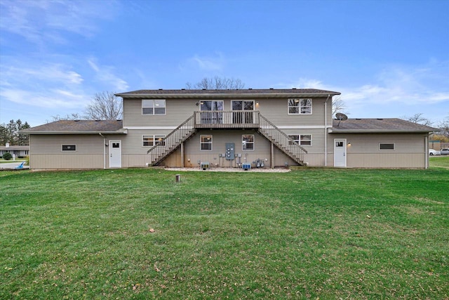 back of property with a lawn and a deck