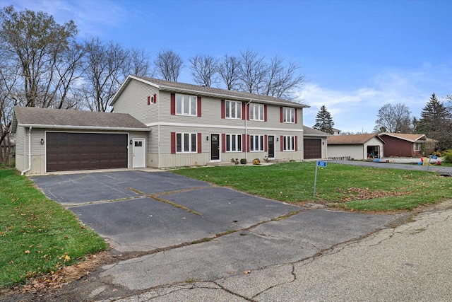 view of front of house featuring a front yard and a garage