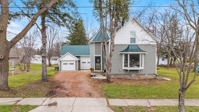 bungalow-style home featuring a garage and a front yard