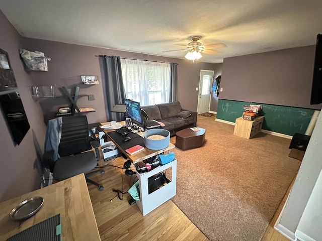 living room with wood-type flooring and ceiling fan