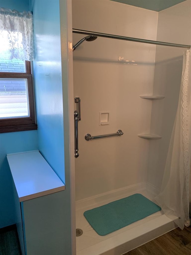 bathroom with a shower with curtain and hardwood / wood-style flooring