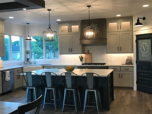 kitchen with a breakfast bar, a center island, dark wood-type flooring, and appliances with stainless steel finishes