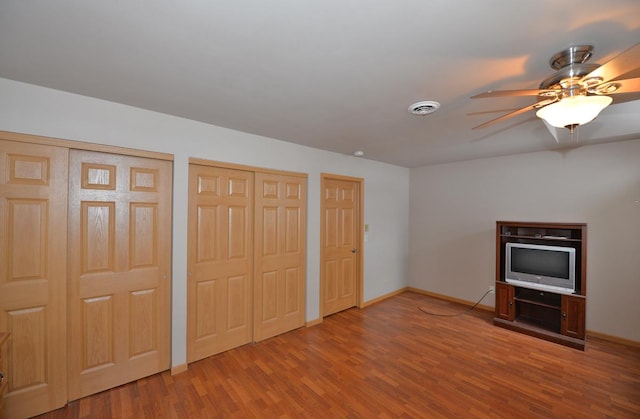 interior space with ceiling fan and hardwood / wood-style flooring