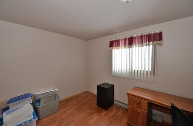 misc room featuring light wood-type flooring and a baseboard heating unit