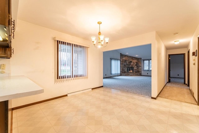 interior space with baseboard heating, a fireplace, vaulted ceiling, and an inviting chandelier