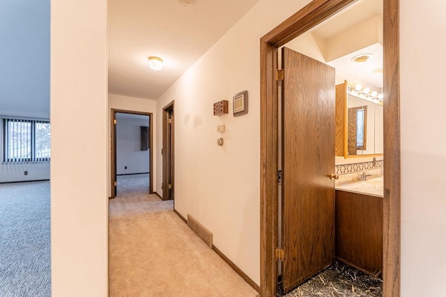 hallway with light colored carpet