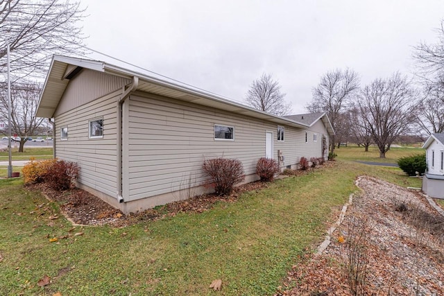 view of property exterior with a lawn