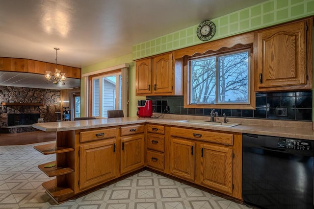 kitchen with dishwasher, sink, a healthy amount of sunlight, hanging light fixtures, and kitchen peninsula