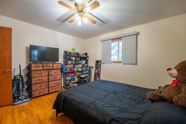 bedroom with ceiling fan and light hardwood / wood-style flooring